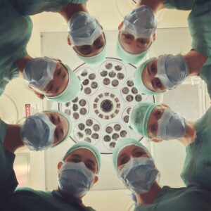 medical malpratice law calgary operating room doctors and nurses above operating table